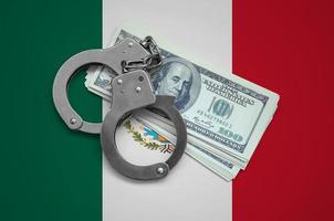 Mexico flag  with handcuffs and a bundle of dollars. Currency corruption in the country. Financial crimes photo