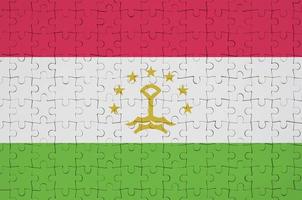 Tajikistan flag  is depicted on a folded puzzle photo