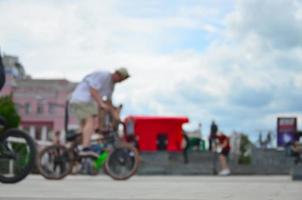 Defocused image of a lot of people with bmx bikes. Meeting of fans of extreme sports photo
