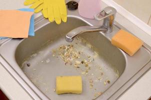 Close up on dirty clogging kitchen sink drain with food particles photo