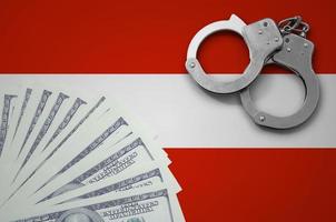 Austria flag  with handcuffs and a bundle of dollars. The concept of illegal banking operations in US currency photo