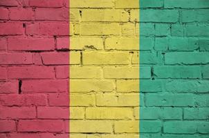 Guinea flag is painted onto an old brick wall photo