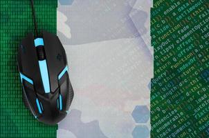Nigeria flag  and computer mouse. Digital threat, illegal actions on the Internet photo