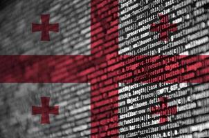 Georgia flag  is depicted on the screen with the program code. The concept of modern technology and site development photo