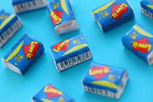 TERNOPIL, UKRAINE - JUNE 23, 2022 Love is - turkish bubble gums from 1990s popular in russian region. Various flavors of Love is chewing gum with liners about love photo