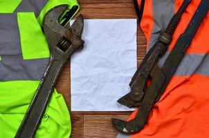 Adjustable wrenches and paper lies of an orange and green signal photo