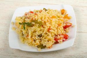 Mexican rice on the plate and wooden background photo