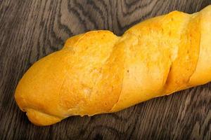 Baguette on wooden background photo