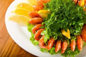 Prawn cocktail on the plate and wooden background photo