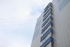 Building has blue balconies. Modern house in city. photo