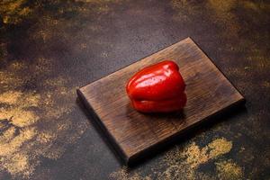 Fresh torn red sweet pepper from the autumn harvest photo