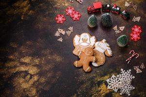 Beautiful gingerbread on a brown ceramic plate with Christmas tree decorations photo