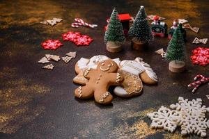 Beautiful gingerbread on a brown ceramic plate with Christmas tree decorations photo