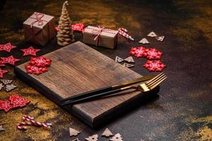 Beautiful gingerbread on a brown ceramic plate with Christmas tree decorations photo