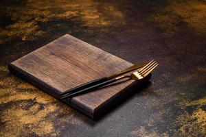 An empty brown ceramic plate on a dark concrete brown background photo