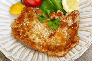 Pork schnitzel on the plate close up view photo