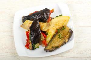 Steamed vegetables on the plate and wooden background photo