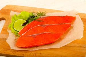 Salted salmon on wooden board and wooden background photo