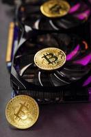 Bitcoin on a graphic card with a Pink neon light on a dark background. photo