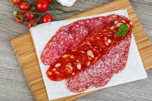 Salami sausage on wood photo