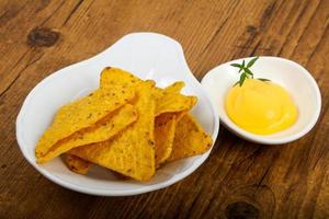 Nachos in a bowl on wooden background photo