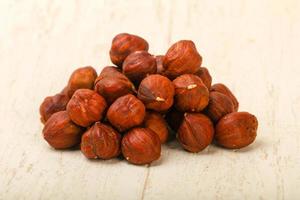 Hazelnut heap on wooden background photo