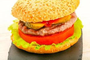 Homemade hamburger on wooden board photo