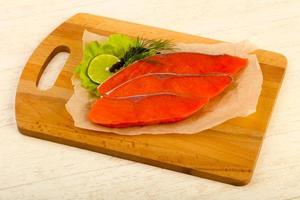 Salted salmon on wooden board and wooden background photo