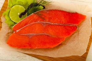 Salted salmon on wooden board and wooden background photo