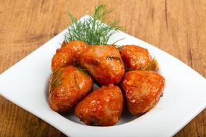 Meat balls in a bowl on wooden background photo