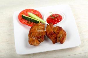 Pork BBQ on the plate and wooden background photo