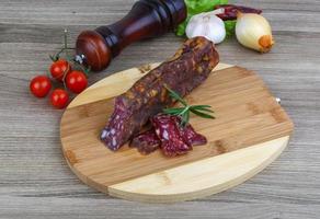 Salami sausage on wood photo