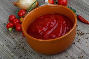 Tomato ketchup on wood photo