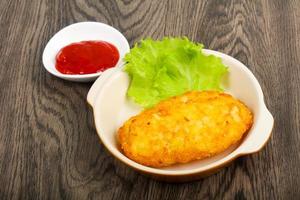 Potato pancake in a bowl on wooden background photo