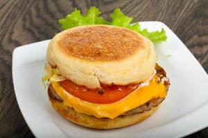 Cheeseburger on the plate and wooden background photo