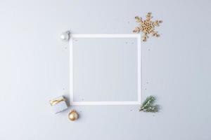 Christmas minimal composition with white frame and packaging gift on grey background. Flat lay, copy space photo