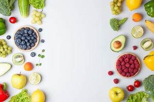 Fresh fruits and vegetables on grey background. Healthy eating concept. Flat lay, copy space. photo