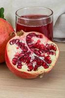 Pomegranate juice on wood photo