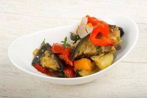 Steamed vegetables in a bowl on wooden background photo