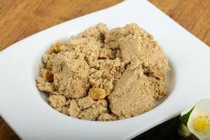 Halva in a bowl on wooden background photo