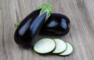 Raw eggplant on wood photo