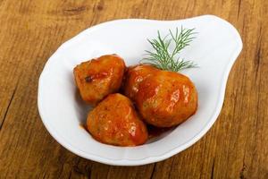 Meat balls in a bowl on wooden background photo