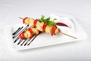 Chicken skewer on white photo