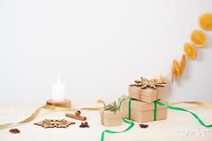 Eco friendly packaging gifts in craft paper on wooden table. Zero waste Christmas holiday concept. Close up, copy space. photo