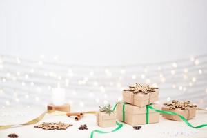 Eco friendly packaging gifts in craft paper on wooden table. Zero waste Christmas holiday concept. Close up, copy space. photo