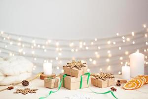 Eco friendly packaging gifts in craft paper on wooden table. Zero waste Christmas holiday concept. Close up, copy space. photo