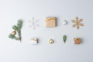 Christmas decorations with packaging gifts and Christmas tree on grey background. Flat lay, copy space photo