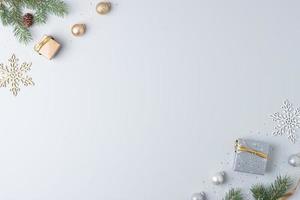 Christmas decorations with packaging gifts and Christmas tree on grey background. Flat lay, copy space photo