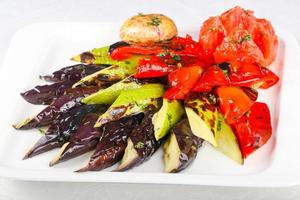 Grilled vegetables on the plate and white background photo