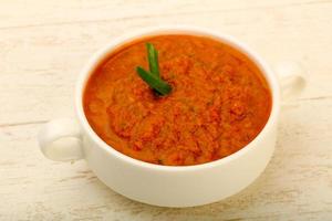 Gazpacho soup in a bowl on wooden background photo